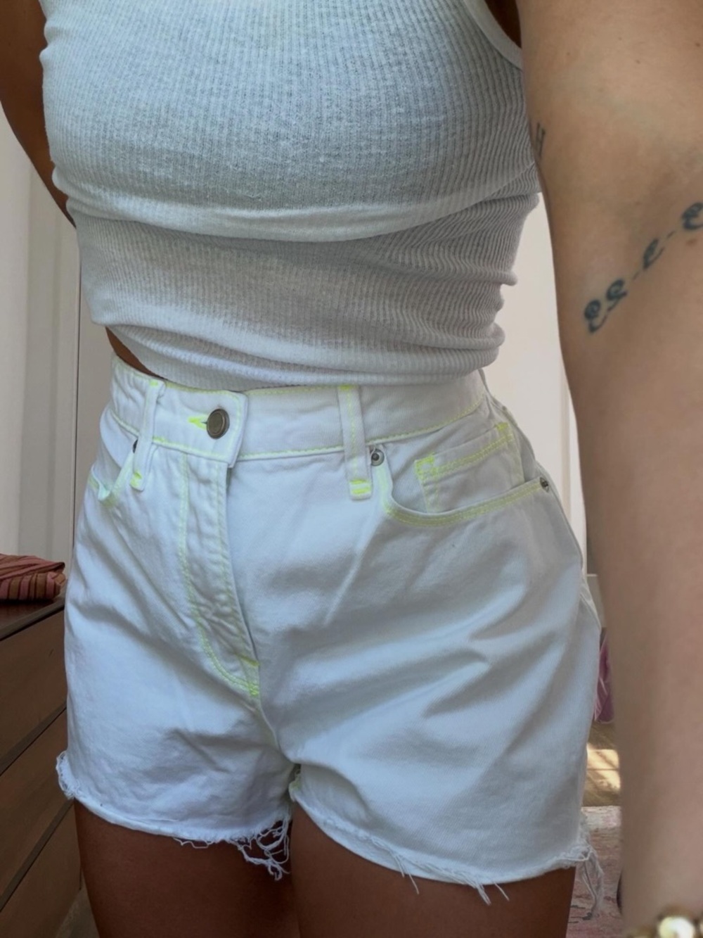 Good American White High-Rise Denim Shorts with Neon Yellow Stitching